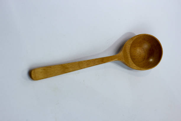istock selective focus of wooden spoon on white background. 1464657776