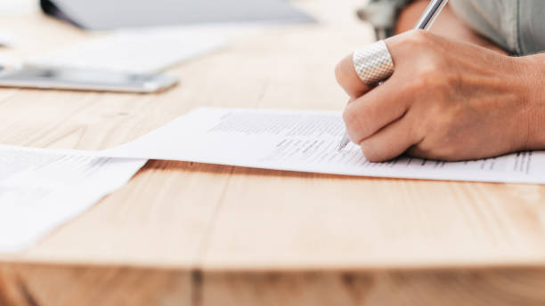 istock close up. business woman writing while sitting at the table 1464657926