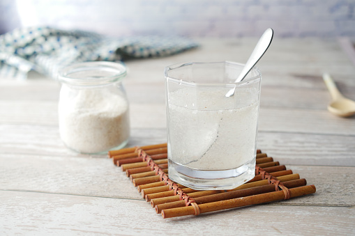 Psyllium Seeds in a glass container on table .