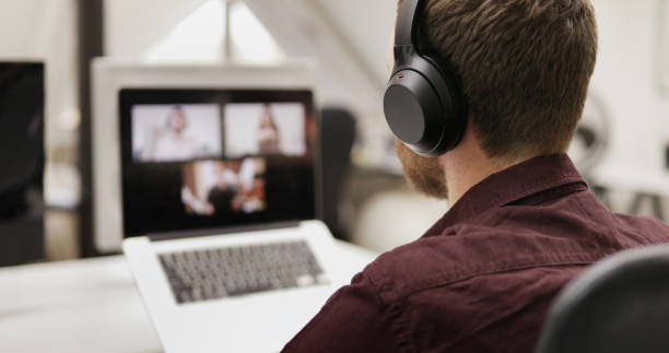 istock Businessman talking with remote colleagues during a laptop video call 1464659265