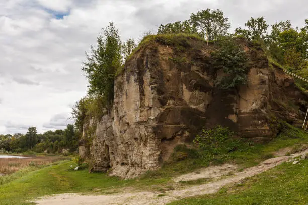 Photo of Exposed rocky cliff with caves in Tori, Estonia. Local name - Devil's caves
