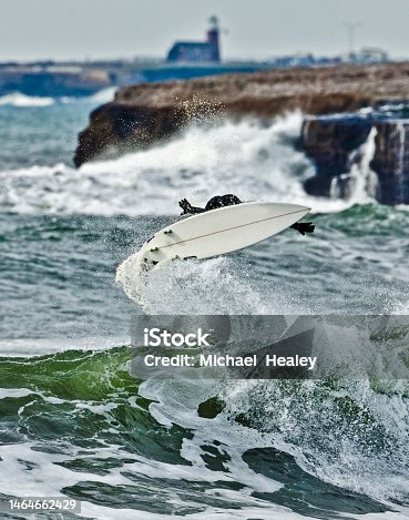 istock Surfer airs in front Santa Cruz Lighthouse 1464662429