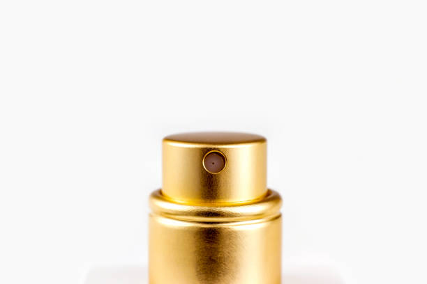 istock Golden perfume spray cap on light background close up with copy space 1464662894