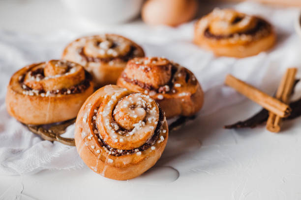 cinnamon rolls recipe and ingredients at table stock photo