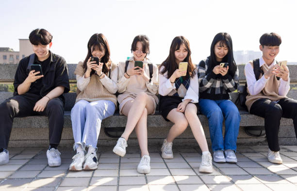 istock Happy young group using the mobile phones at school 1464665570
