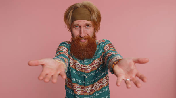 istock Hippie man opening hands, glad to see preparing surprise, sharing love congratulating presents gifts 1464667146