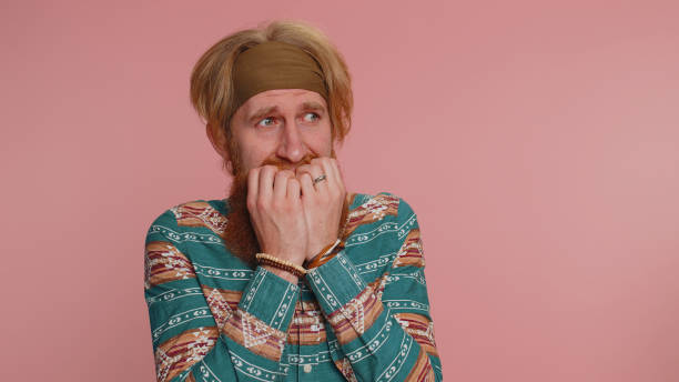 istock Scared frightened hippie man biting nails, feeling worried nervous about serious troubles, stress 1464667151
