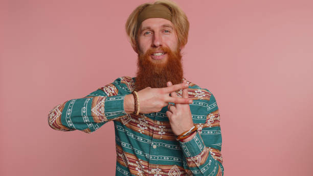 istock Hippie man show hashtag symbol with hands, likes tagged message popular viral internet content sign 1464667152