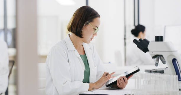 istock Scientist, woman and digital tablet in laboratory for planning, innovation and web research. Female worker, online medicine and science development for solution, data analysis and biotechnology app 1464672202