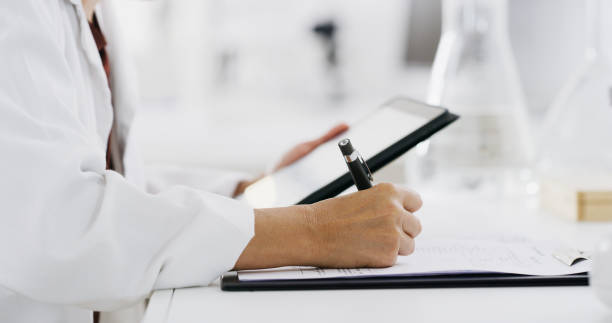 Scientist with tablet, science and writing notes for medical research and digital test results, study and checklist. Biotechnology, scientific innovation and online data with person hand in lab
