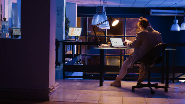 istock Advisor agent checking corporate report late at night 1464677459