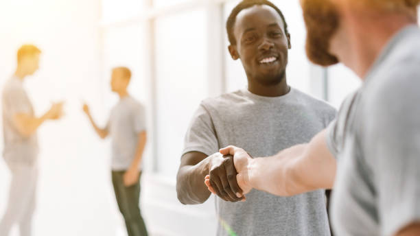 istock close up. successful young people shaking hands. 1464679862