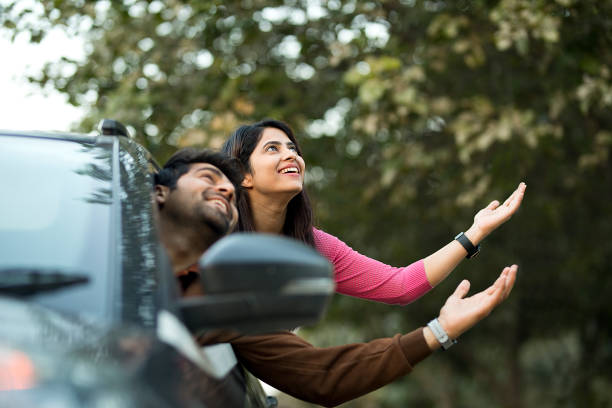 istock Cheerful couple looking out from car window 1464681767