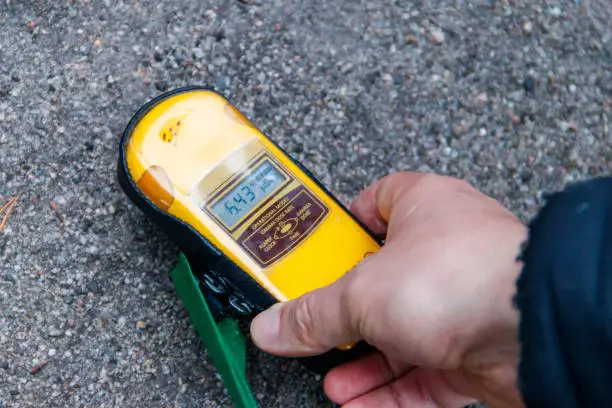 Male hand holding a dosimeter. Measurement of radiation levels by the Geiger counter in Chernobyl Exclusion Zone, Ukraine