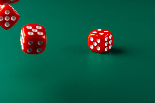 istock Red dice on green background close up 1464682946