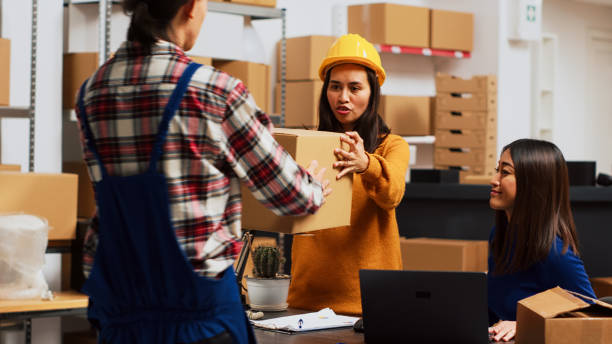 istock Group of people checking products in boxes 1464683351