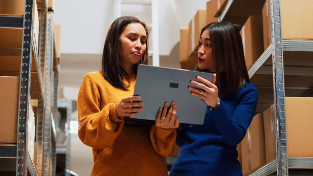 istock Team of asian women analyzing stock in boxes 1464683890