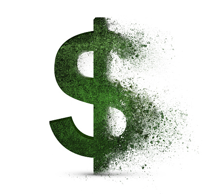 green dollar symbol that crumbles into dust on a white isolated background