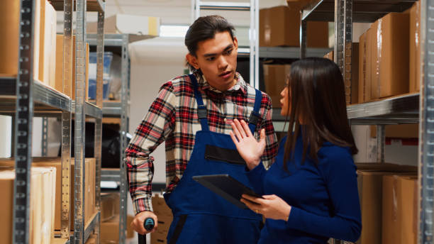 istock Asian man in crutches working with entrepreneur in depot 1464684072