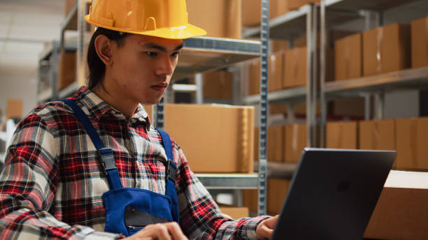 istock Asian man checking merchandise quality in warehouse 1464684347