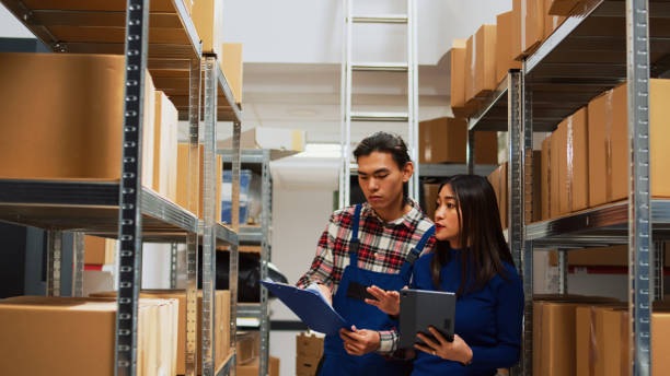 istock Asian employees checking warehouse supplies on tablet 1464684366
