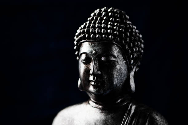 istock Meditating Buddha Statue on dark background. Soft focus. Close up. Copy space. 1464685849