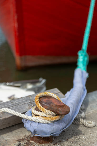 istock A rope is wrapped around a rusty bollard. 1464686054