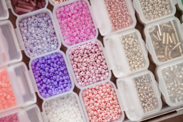 istock Making jewelry with colorful beads in plastic container 1464687346