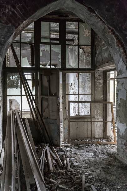 istock Vertical shot of debris inside an old, abandoned, and damaged building 1464687380