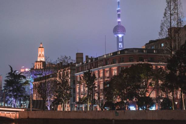 Modern buildings along the Suzhou Creek at night in Shanghai, Chin Shanghai, China – January 29, 2022: The modern buildings along the Suzhou Creek at night in Shanghai, China suzhou creek stock pictures, royalty-free photos & images