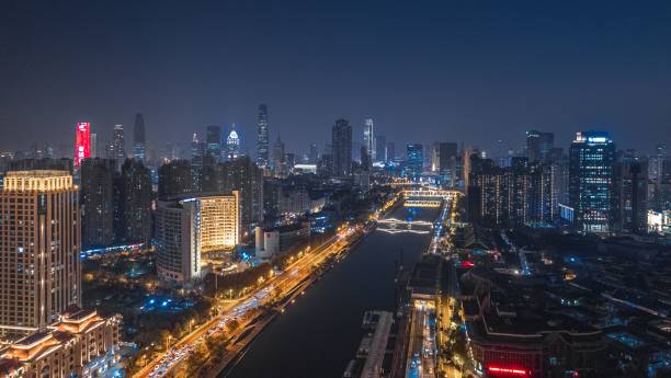 istock Drone modern cityscape view with a river and illuminated buildings at night 1464688852