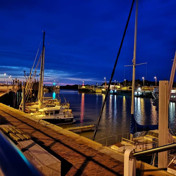 istock Harbour surrounded by ships on the sea under a cloudy sky in the evening 1464688880