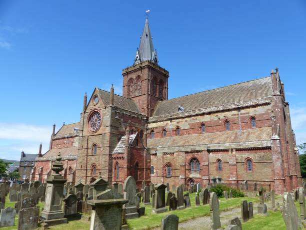 st magnus cathedral with graves on a cemetery in kirkwall, scotland with blue sky - uk cathedral cemetery day imagens e fotografias de stock