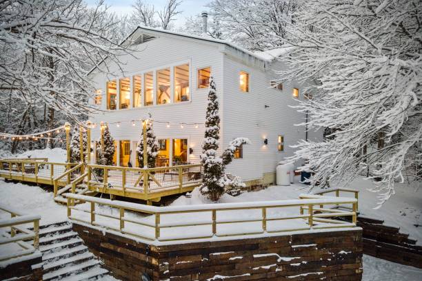 istock Beautiful white house surrounded by trees on a snowy winter day 1464690671