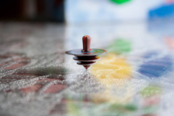 istock Selective focus shot of a spinning top on a colorful table with light hitting it 1464690762