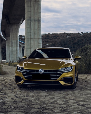Prague, Czech Republic – November 23, 2022: A vertical shot of a Volkswagen Arteon gold color