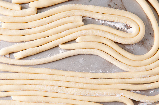 a tray of hand rolled pci pasta made from scratch