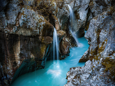 Waterfall falling among rocky mountains in Slovenia. Photographed in medium format.