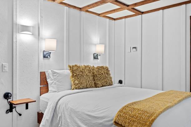 istock Stylish modern bedroom with a large bed and lamps 1464693946
