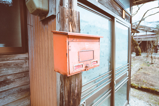 Teenage Girl collecting mail from mailbox