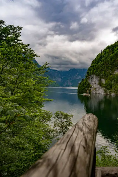 A vertical shot of a lake and mountains in the forest Malerwinkel in Koenigssee in Bavaria