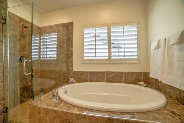 istock Luxury bathroom interior design with marble brown tiles and a window 1464695484