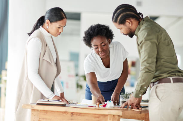 istock Teamwork, architect and meeting with a business team in their office working on a design for building. Architecture, engineer and designer with a man and woman employee group at work on strategy 1464697807