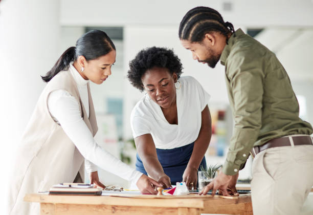 istock Collaboration, architecture or planning with a business team in their office working on a design for building. Architect, engineer and designer with a man and woman employee group at work on strategy 1464697809