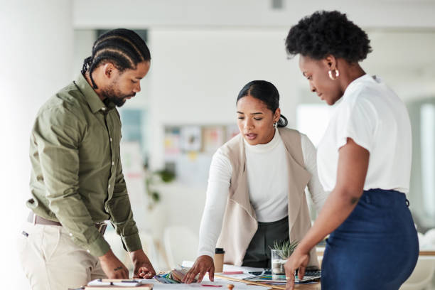 istock Teamwork, architect and design with a business team in their office working on a design for building. Architecture, engineer and designer with a man and woman employee group at work on strategy 1464697820
