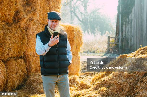 Farm Worker On Smart Phone Video Call In Countryside Stock Photo - Download Image Now