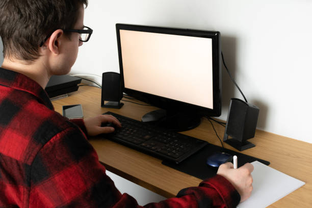 istock Spanish Caucasian teenager in an online class with his computer and taking notes, indoors 1464698587