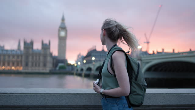 Young Adult Caucasian Walking By Thames Riverbank