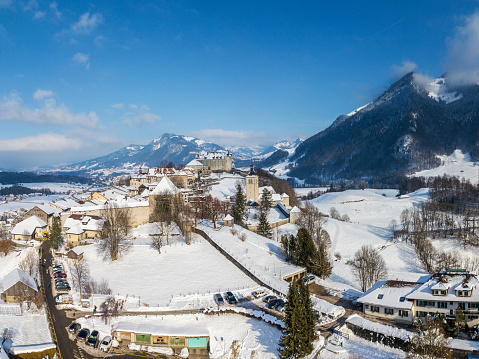 Aerial image of the medieval town Gruyeres with Castle on the hill top of Alps in winter. It is one of the most popular tourist destionations.