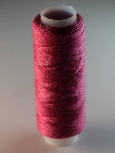 istock Vertical shot of a crimson sewing thread 1464700612